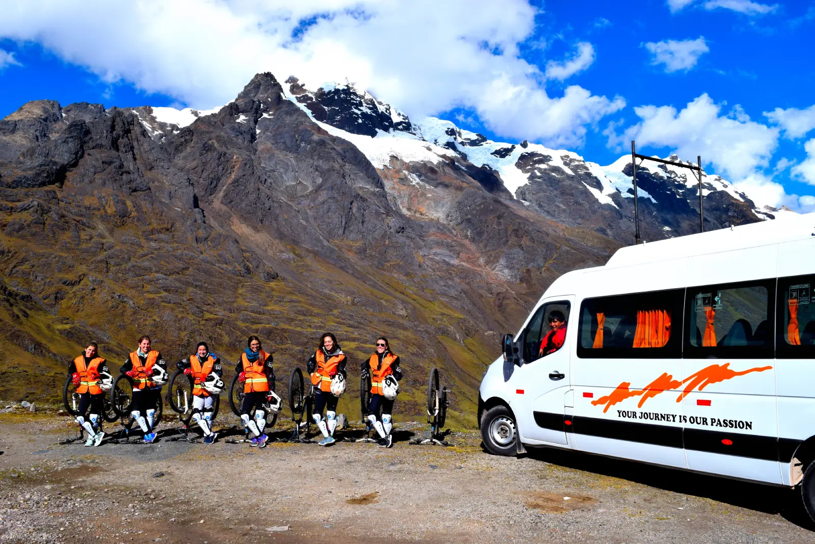 Travelers with bikes and safety gear at Abra Malaga before the downhill biking section of the Inca Jungle Trek.