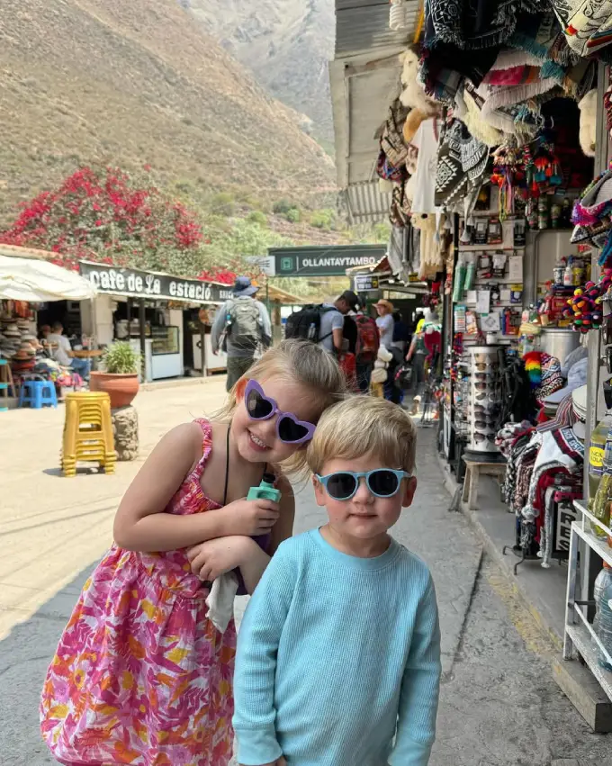Big sister and little brother walking on the streets of Cusco before a family trip to Machu Picchu
