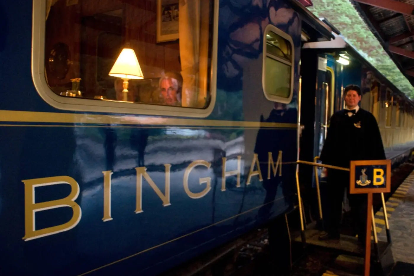 Hiram Bingham train stopped at the station, featuring classic blue carriages and luxury rail service to Machu Picchu.