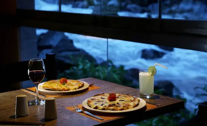 Hotel breakfast service in Aguas Calientes beside a window facing the river