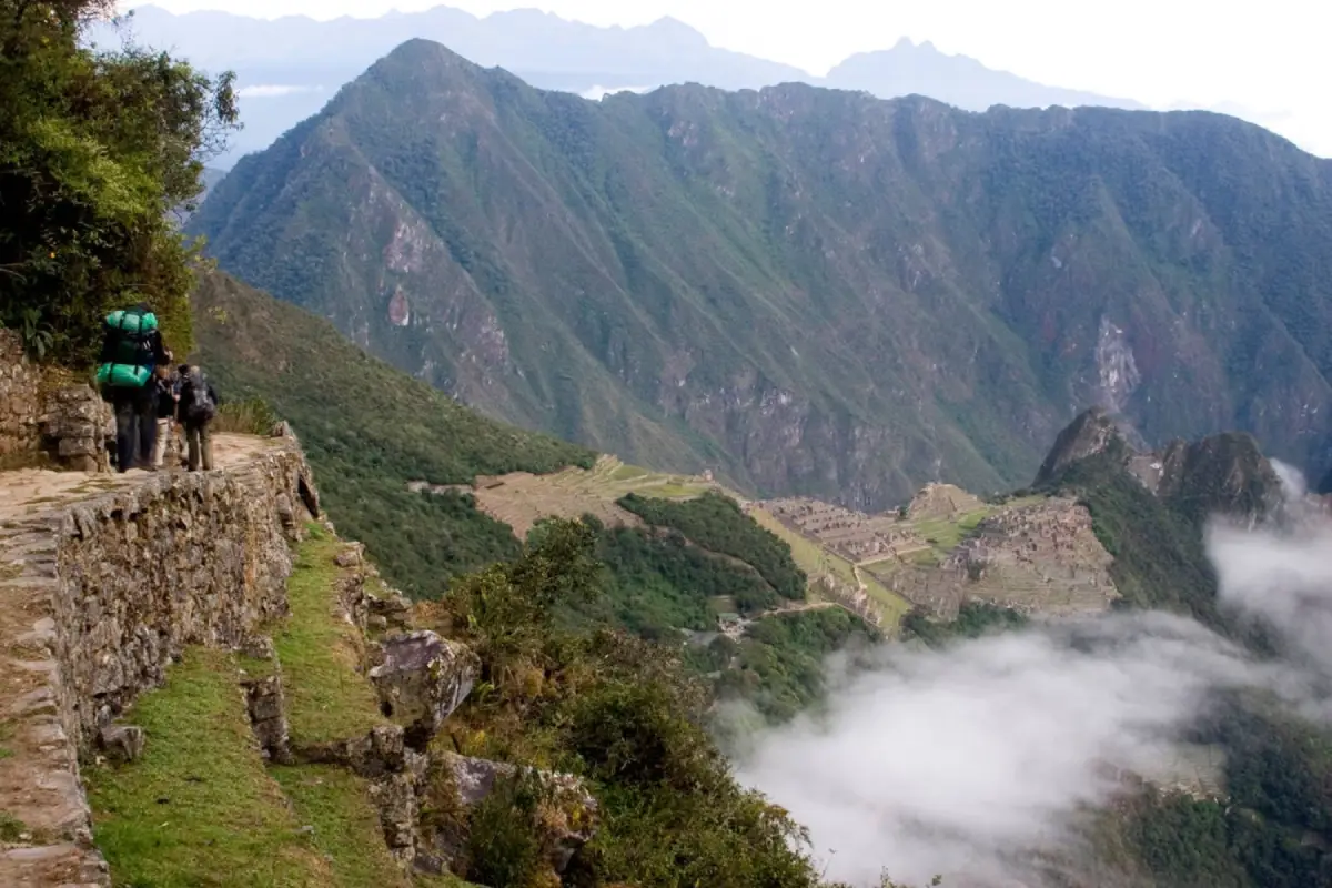 Después de cruzar el Camino Inca y llegar al Intipunku, los caminantes comienzan el descenso final hacia Machu Picchu con una de las vistas más amplias de la ciudadela.