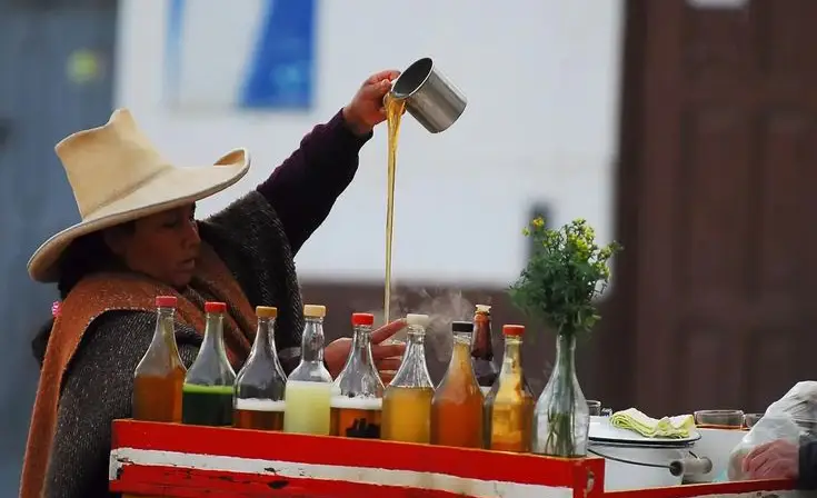 Hot emoliente prepared by street vendor in Peru.