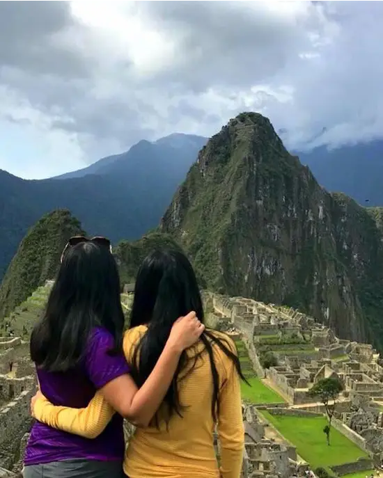 Mother and daughter enjoying the panoramic view of Machu Picchu