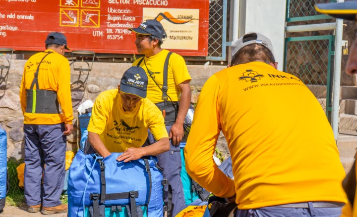 Inca Trail porters organizing and preparing tourists' luggage before setting off.