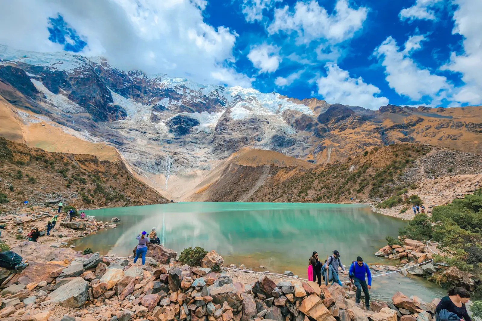 Turquoise Humantay Lake below snowy mountains, one of the main scenic stops on the Salkantay Trek.