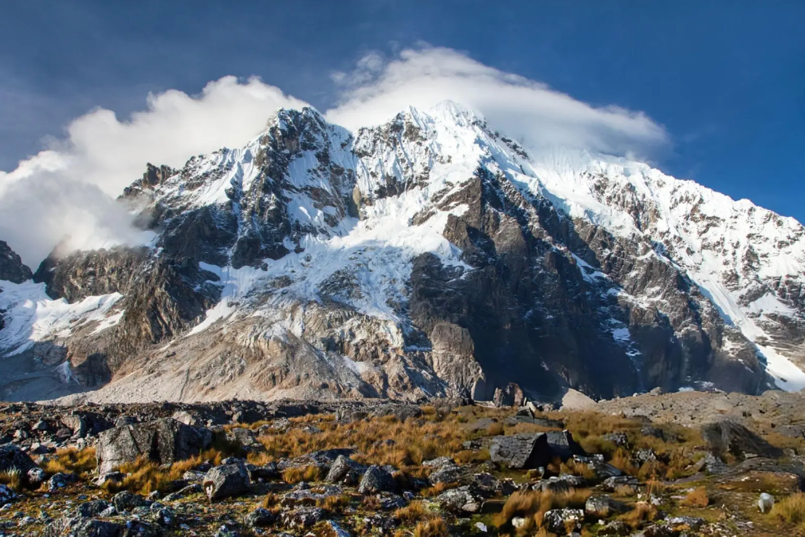 Snow-covered Salkantay Mountain rising above rocky puna terrain in the Cusco highlands.