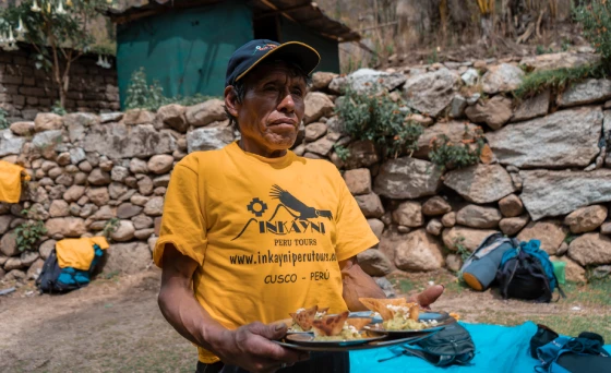 The Inca Trail porter team helping to serve food at the campsite.