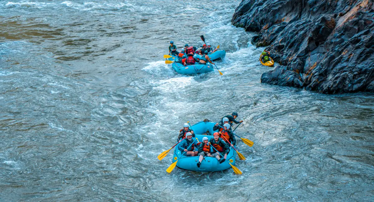 Rafting groups navigating rapids on the Urubamba River during the Inca Jungle trek to Machu Picchu.