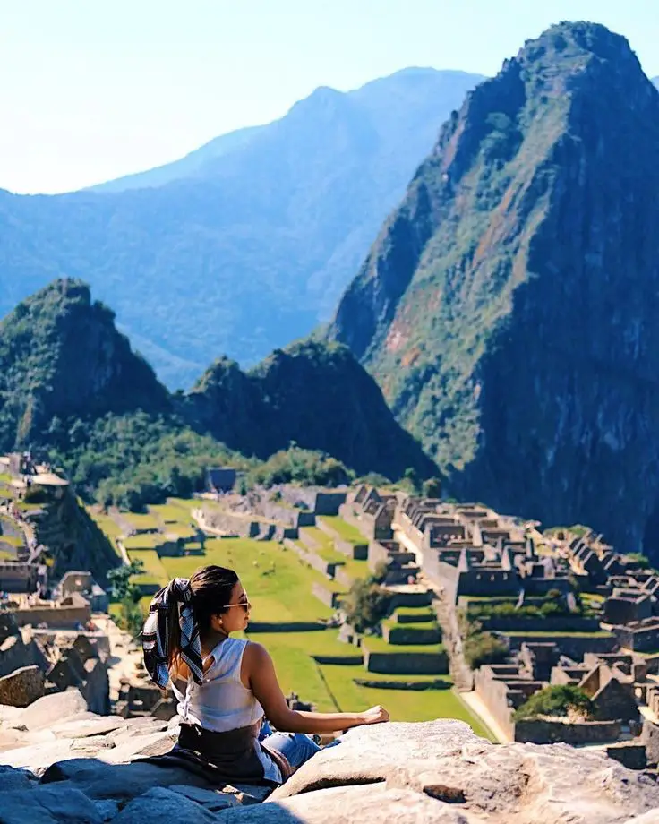 Traveler posing in front of Machu Picchu during a clear weather day