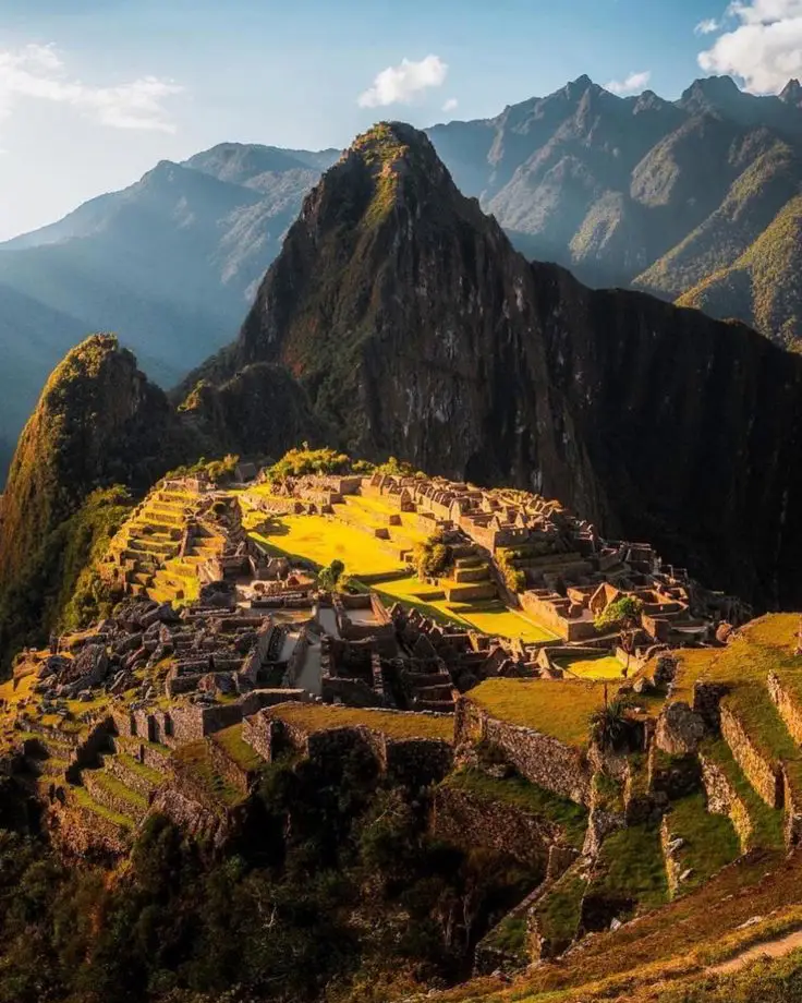 Late afternoon light over Machu Picchu with mountains, valley, and Huayna Picchu in the background
