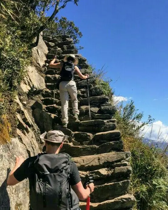 aguas calientes to machu picchu altitude stairs hike route path foreign tourist sun blue sky