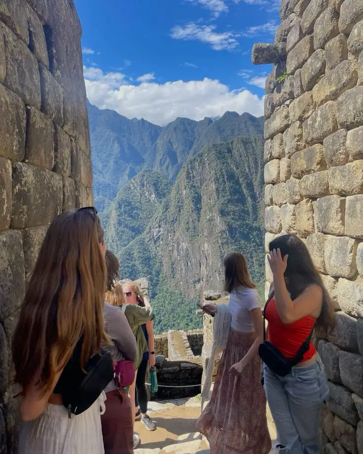 aguas calientes to machu picchu friends foreign tourists panoramic view mountains sky clouds
