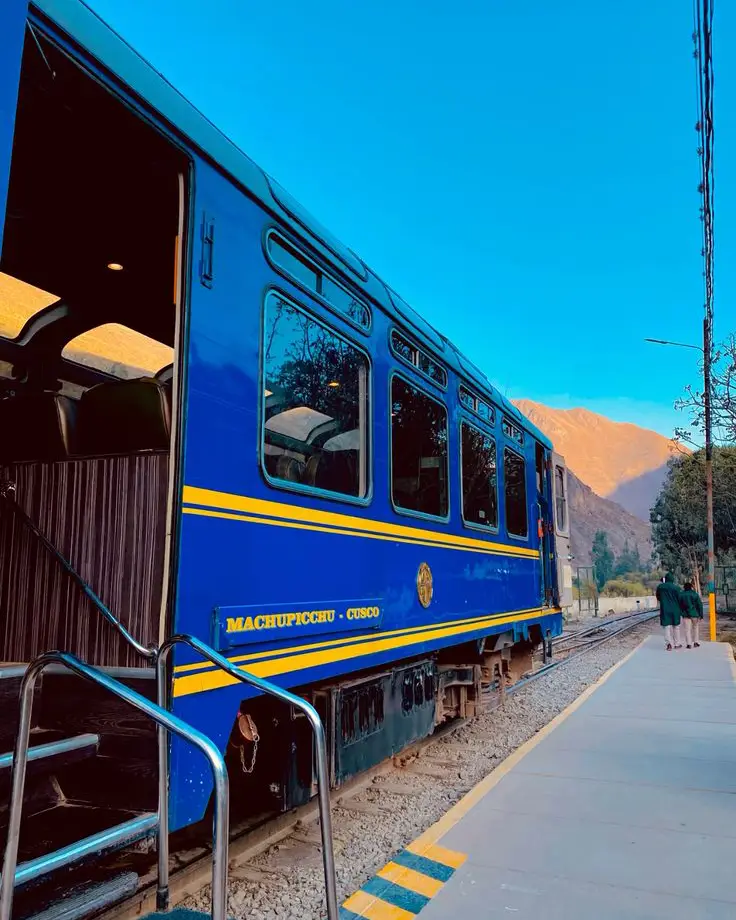Blue train traveling through the Sacred Valley toward Machu Picchu Pueblo