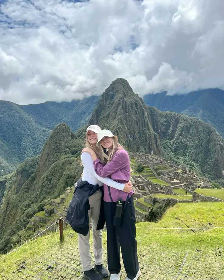 Friends traveling to Machu Picchu from the USA with mountain views and blue sky