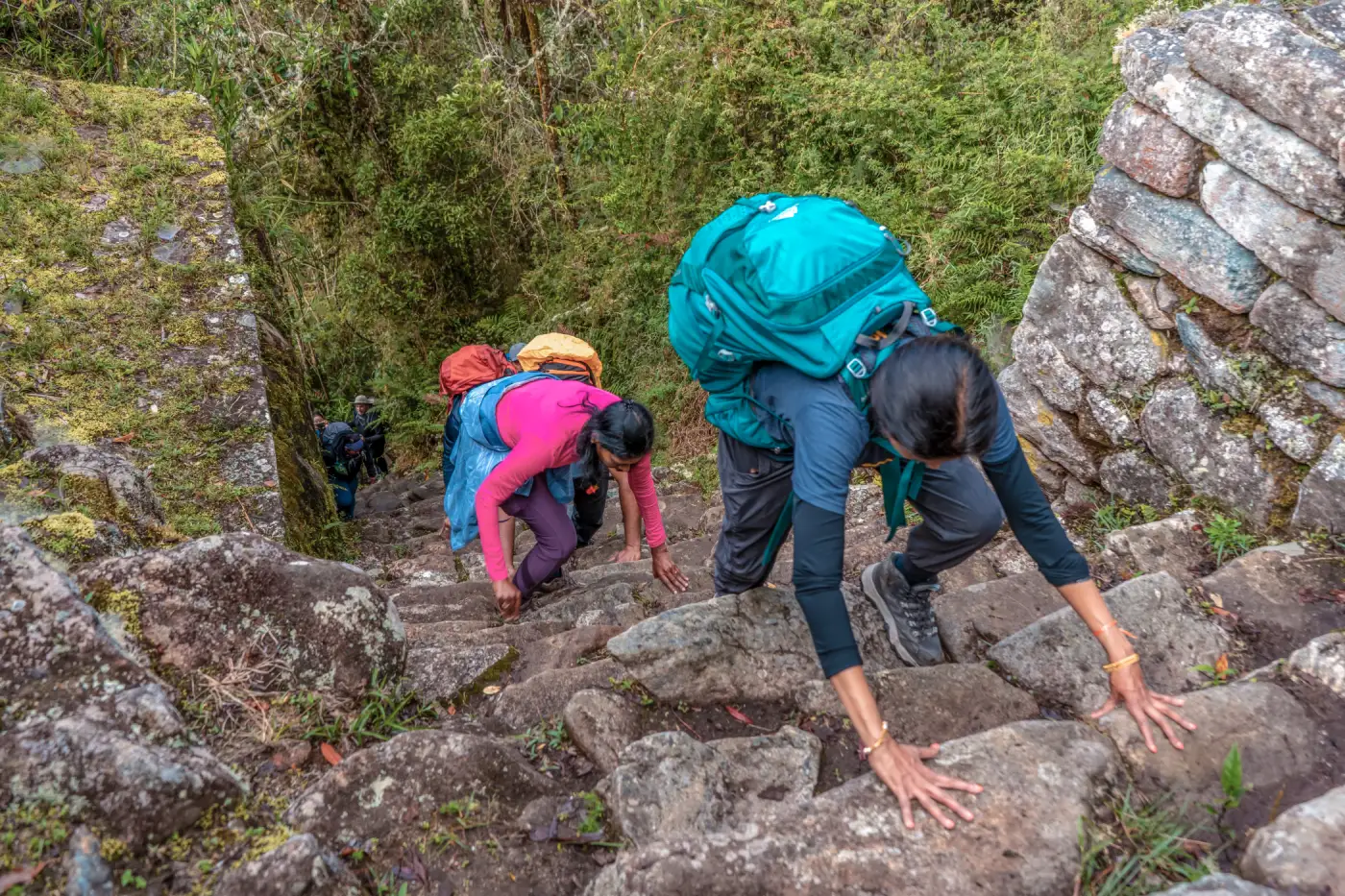 Hikers climb stone stairs near Wiñay Wayna on the final stretch of the Inca Trail.