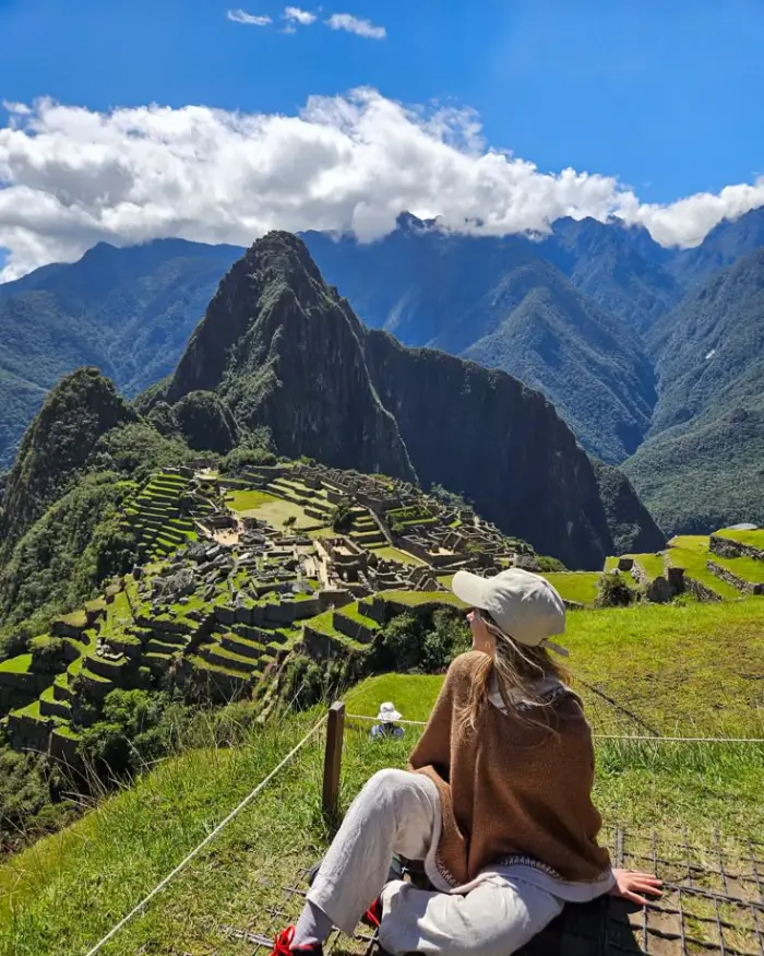 exploring Machu Picchu cusco peru mountain sky cloud blue green woman tourist