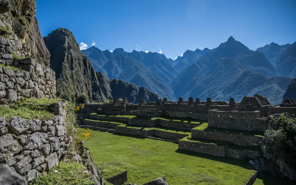 exploring Machu Picchu cusco peru mountain green blue sky stones path vegetation