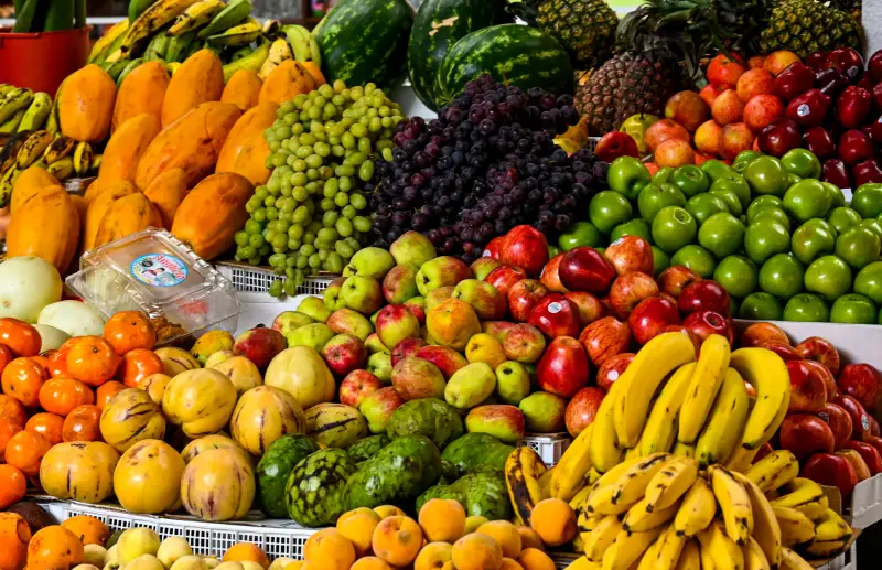 Fruit stand at San Blas Market in Cusco with apples, grapes, bananas and tangerines