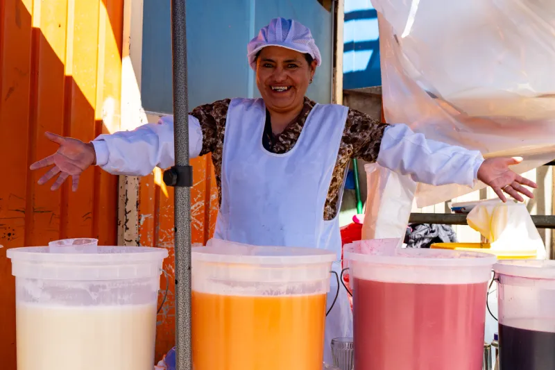 Local Vendor with Traditional Chicha drinks in Cusco (Inkayni Peru Tours)
